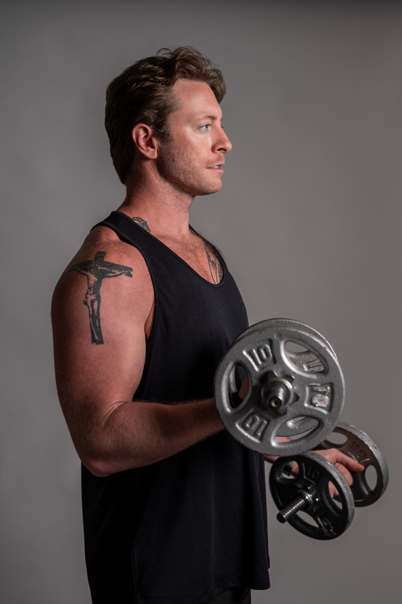Austen Alexander performing a dumbbell curl during hybrid athlete training